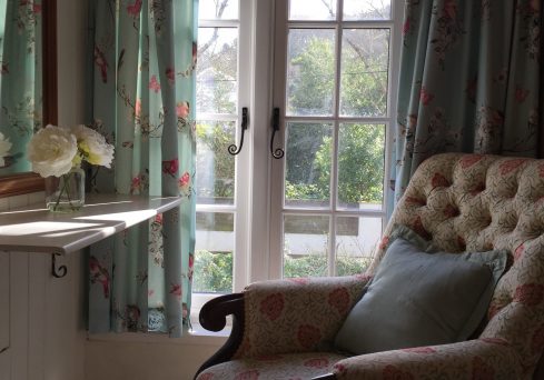 County interiors with soft floral furnishings at Penwartha Cottages